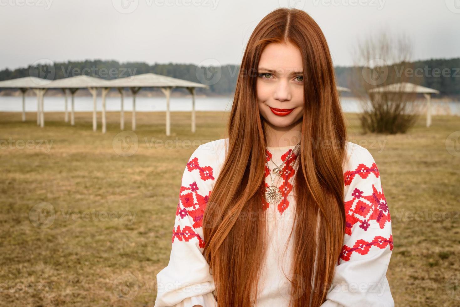 jonge vrouw in Slavische Wit-Russische nationale oorspronkelijke pak buitenshuis foto