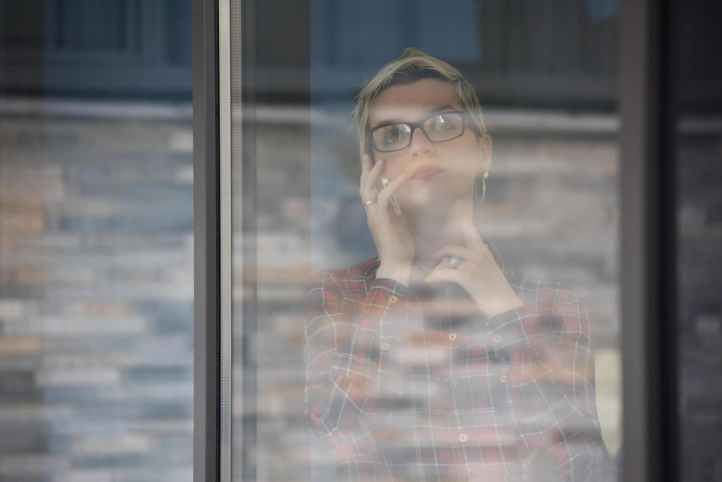 bedrijf vrouw Bij kantoor sprekend door telefoon team Aan vergadering in achtergrond foto