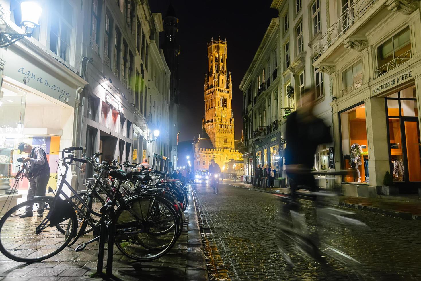 Brugge, belgie - september 19, 2014. oud versmallen straat in de stad centrum met de belfort visie in de einde en veel van Fietsen, de meest populair vervoer. foto