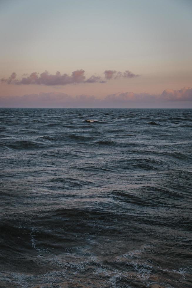 gedempte zonsondergang over de oceaan foto