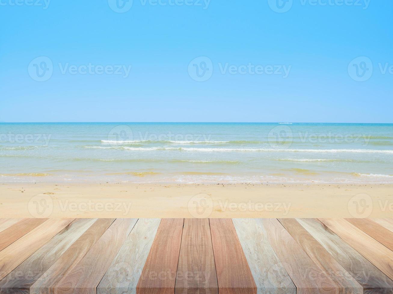 houten tafel top met strand en zee achtergrond, blanco voor ontwerp achtergrond foto