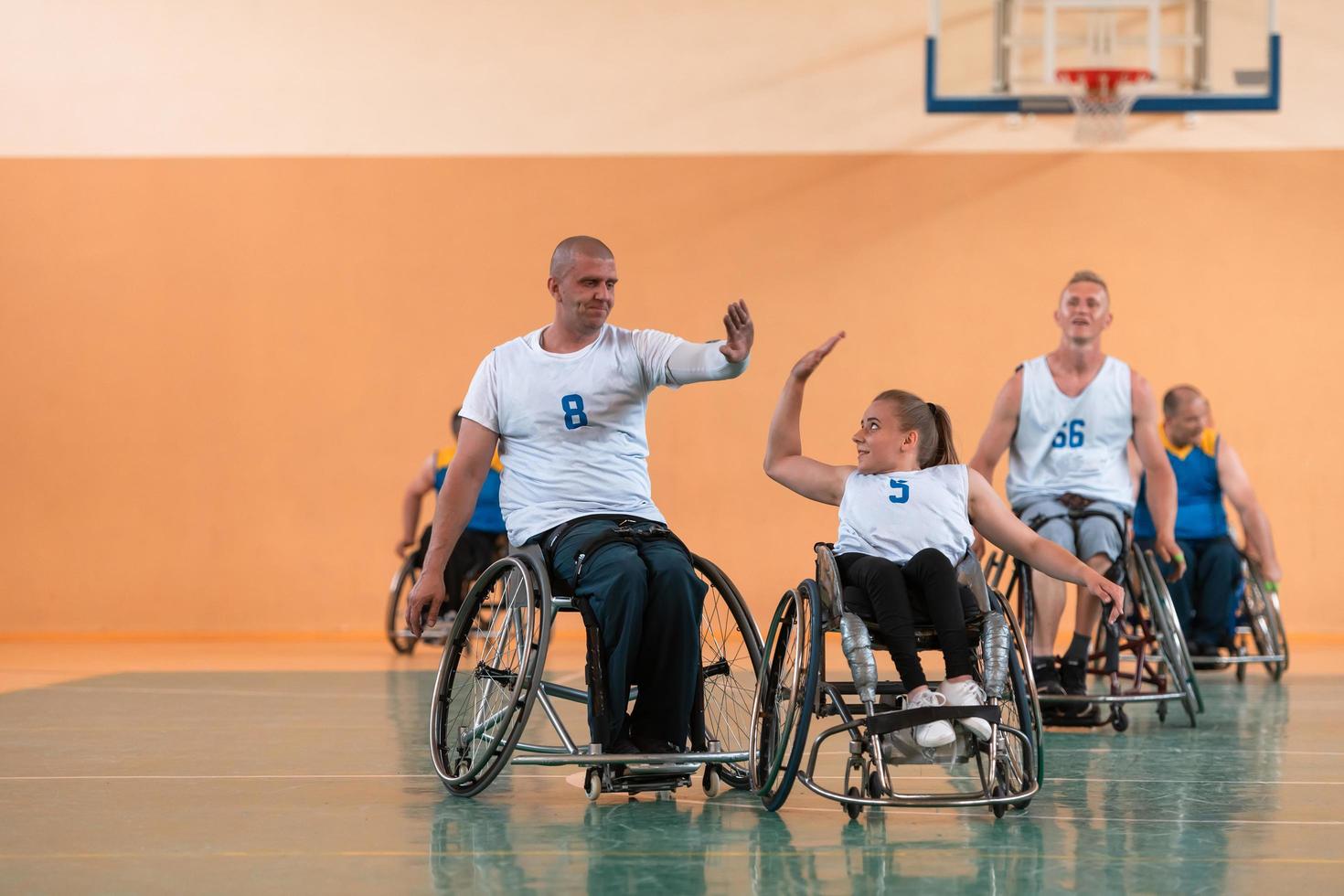 een team van oorlog veteranen in rolstoelen spelen basketbal, vieren points won in een spel. hoog vijf concept foto