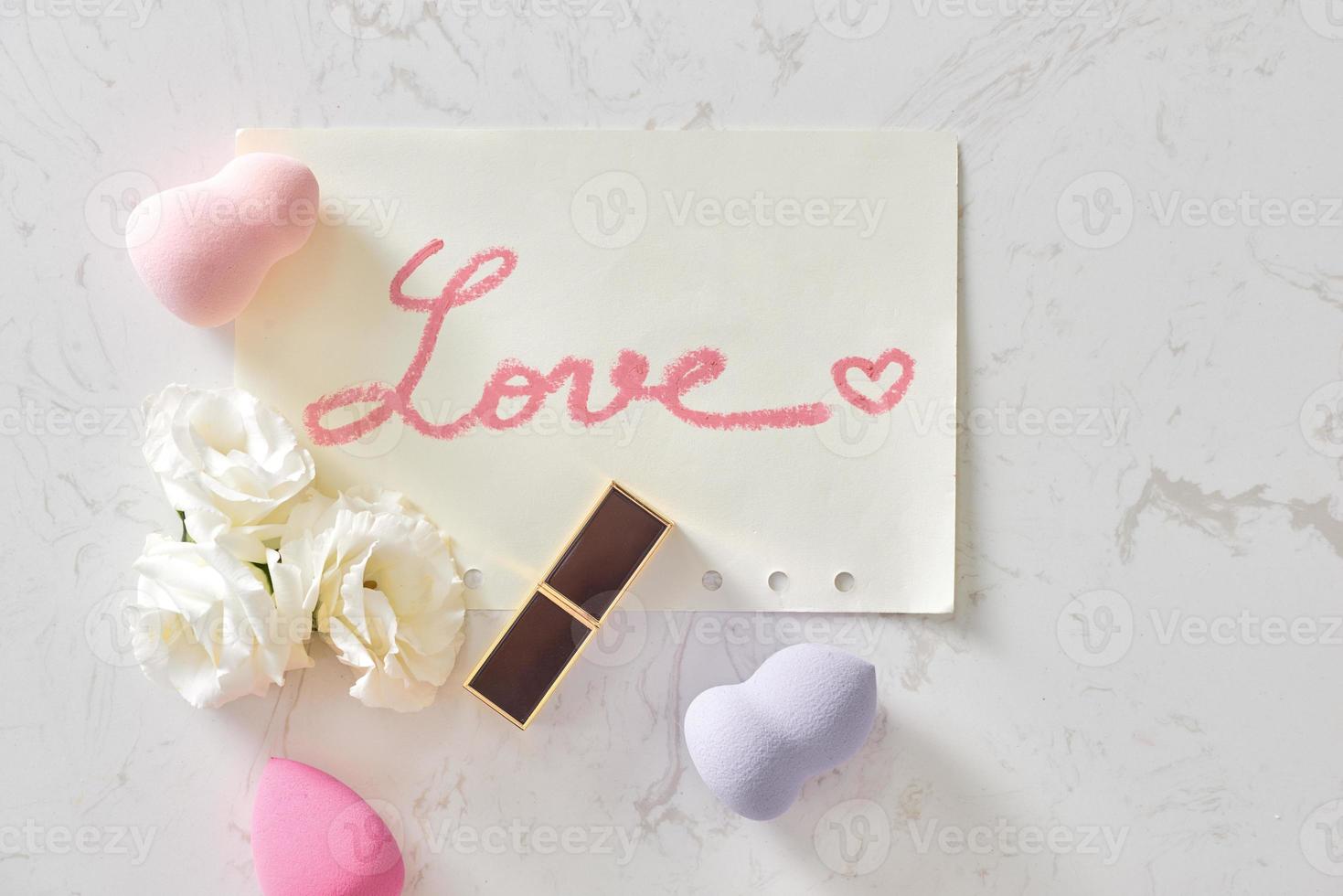 roze valentijnsdag dag vlak leggen met een lippenstift kus en bloemen. top visie foto