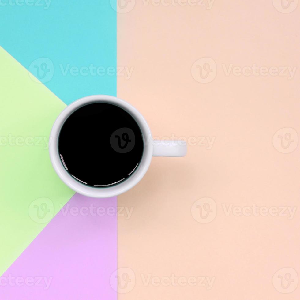 klein wit koffie kop Aan structuur achtergrond van mode pastel roze, blauw, koraal en limoen kleuren papier foto
