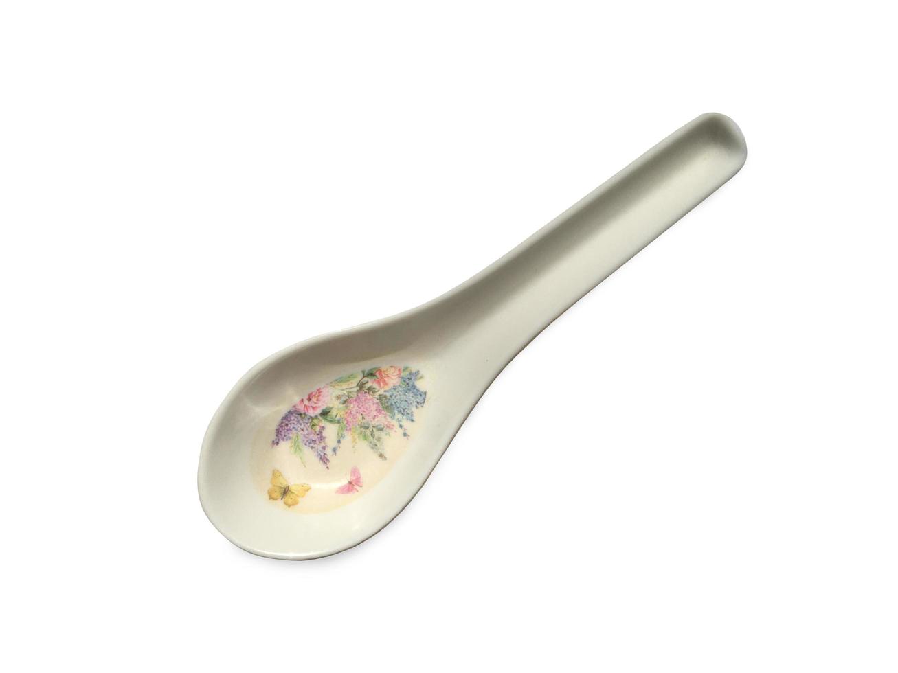 wit lepel met een patroon van bloemen Aan wit achtergrond. knipsel pad foto