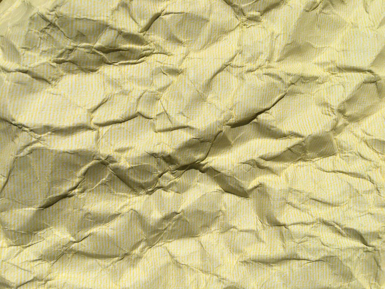 geel verfrommeld papier achtergrond met patroon voor ontwerp foto