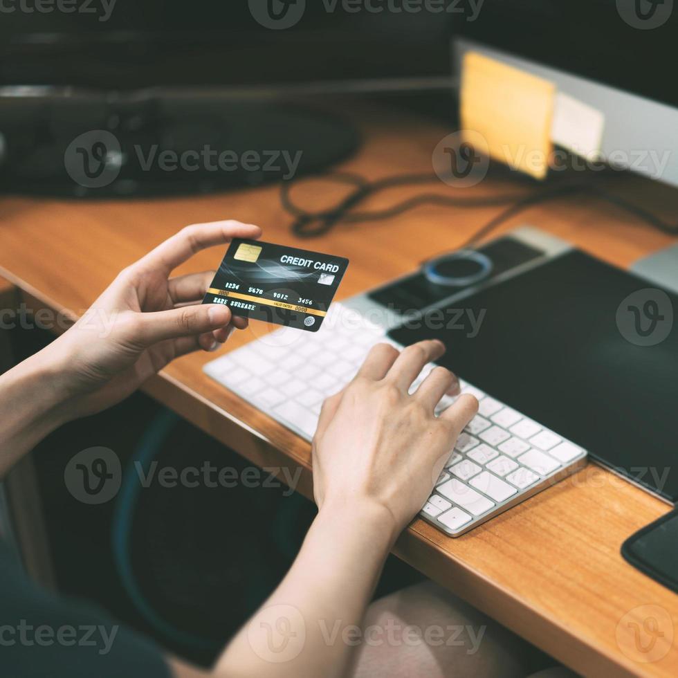 jong volwassen vrouw blijven Bij huis hand- Holding credit kaart voor boodschappen doen online en e-commerce. foto