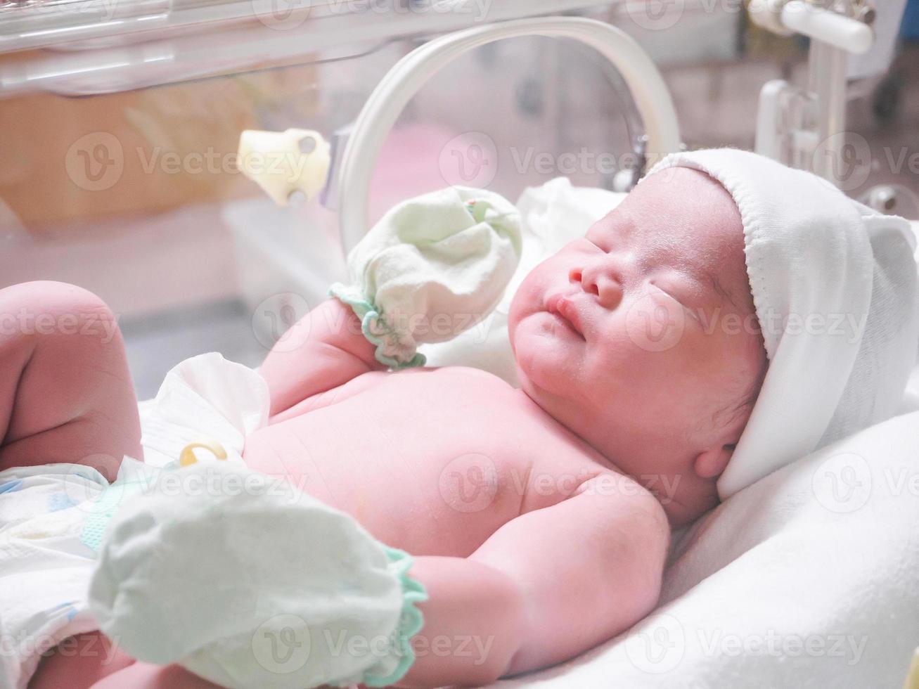 pasgeboren baby zuigeling slaap in de incubator Bij ziekenhuis foto