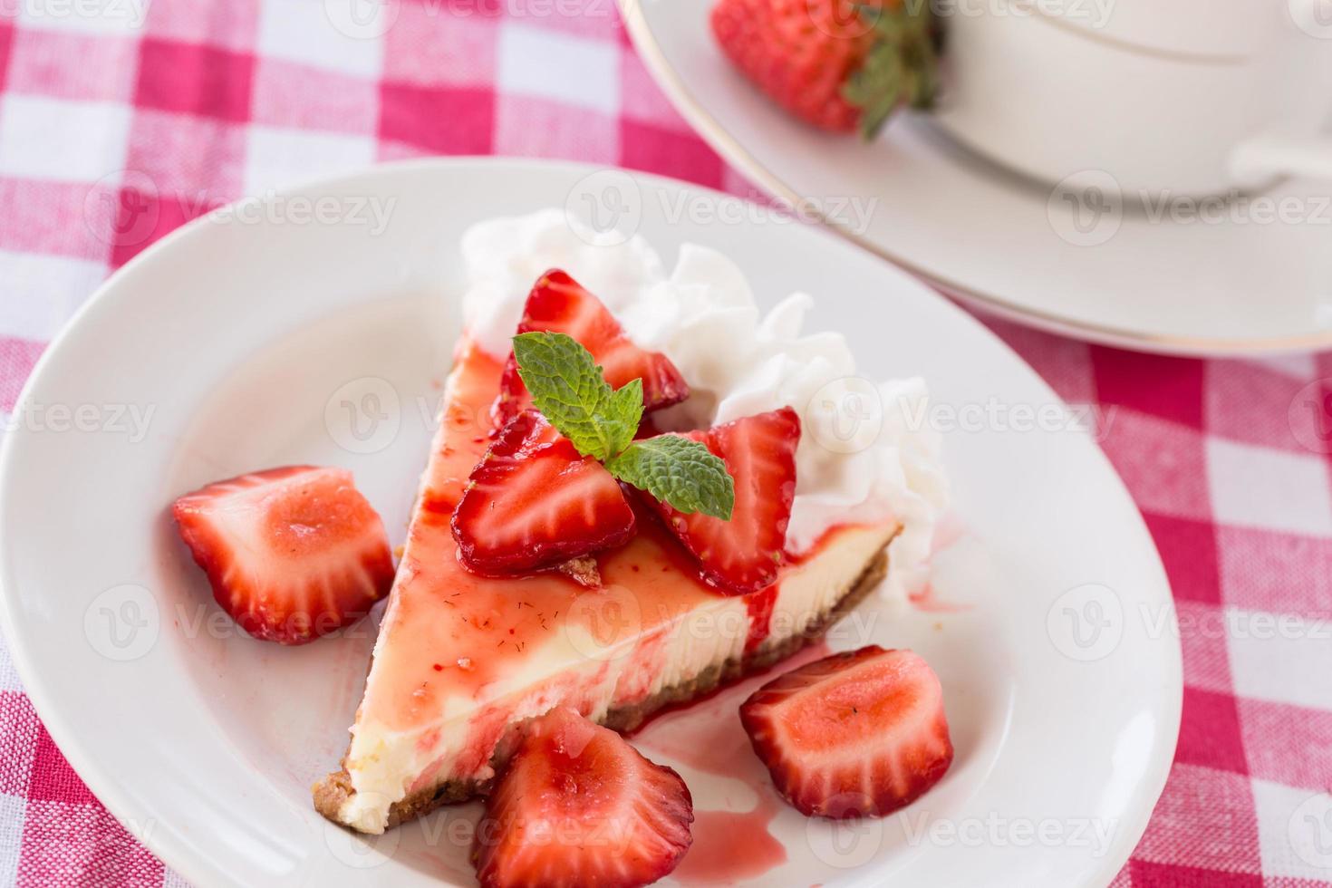 stuk cheesecake met vers gesneden aardbeien foto
