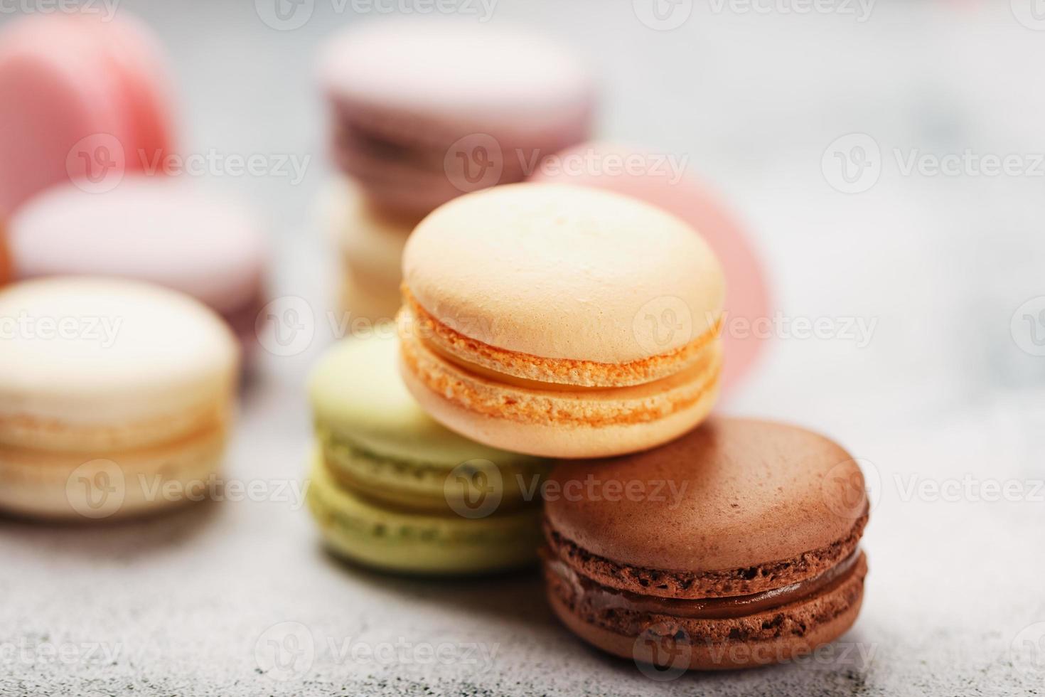 Frans macaroni koekjes van verschillend kleuren zijn Aan de grijs tafel. nog steeds leven van banketbakkerij. foto