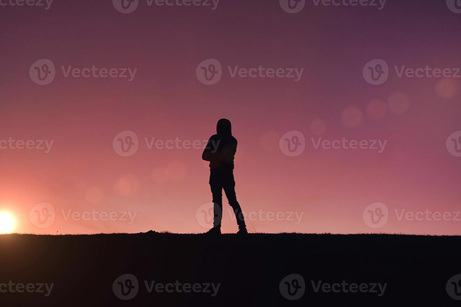 Mens trekking in de berg met een zonsondergang achtergrond in zomertijd foto