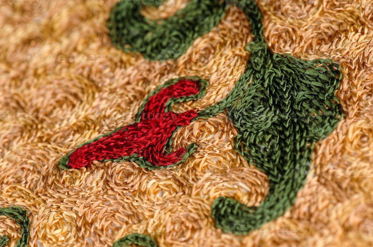 een detailopname schot van nationaal ornamenten en patronen van centraal Azië Aan een stuk van kleding stof foto