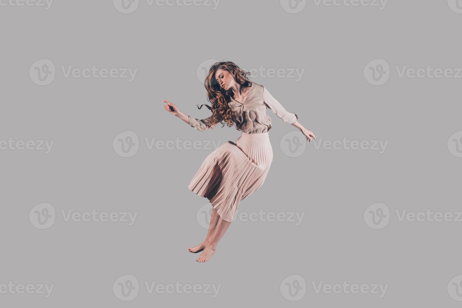vrijheid in elke Actie. studio schot van aantrekkelijk jong vrouw zweven in lucht foto