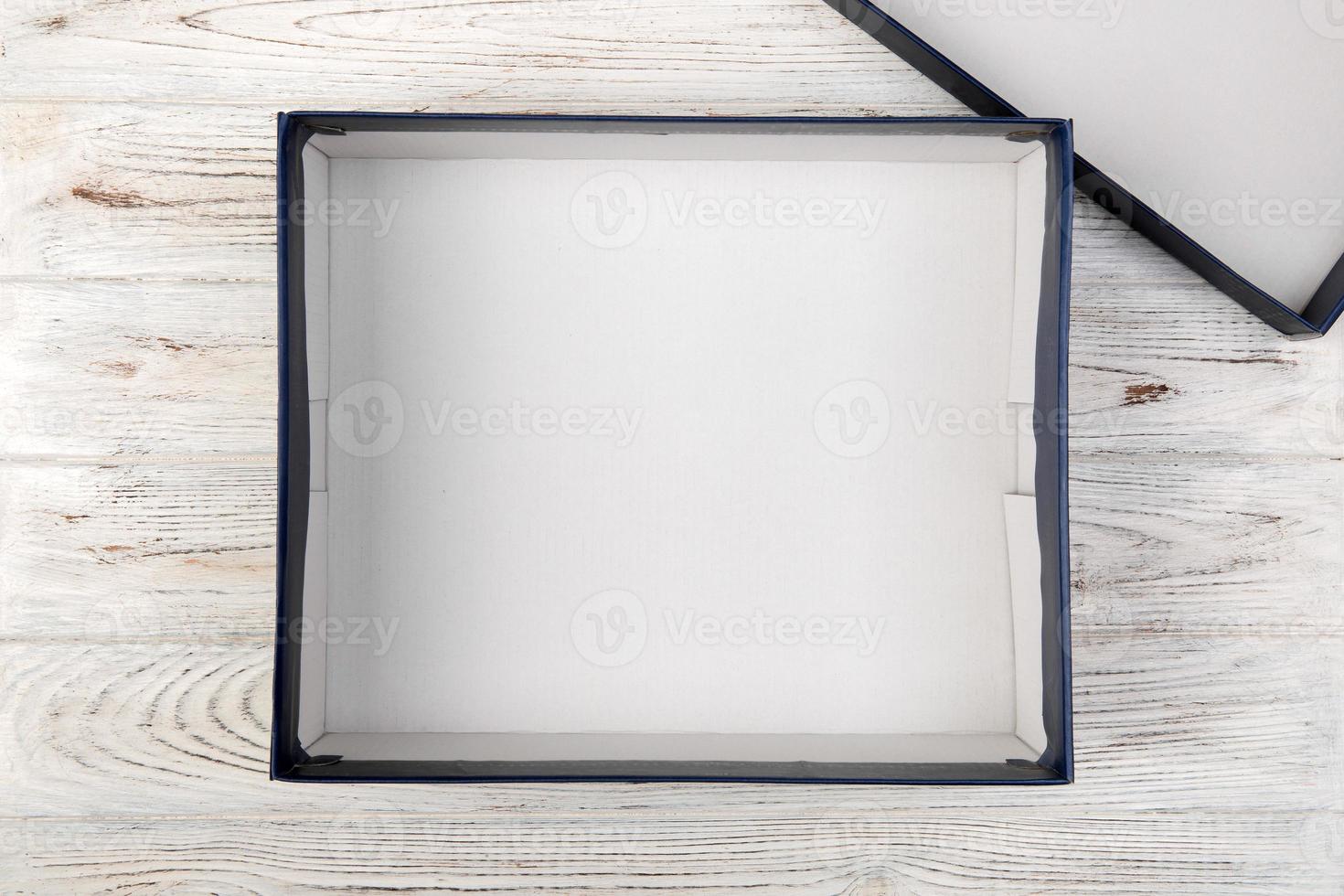 een leeg blanco wit doos Aan de bureau top visie Aan wit houten achtergrond foto