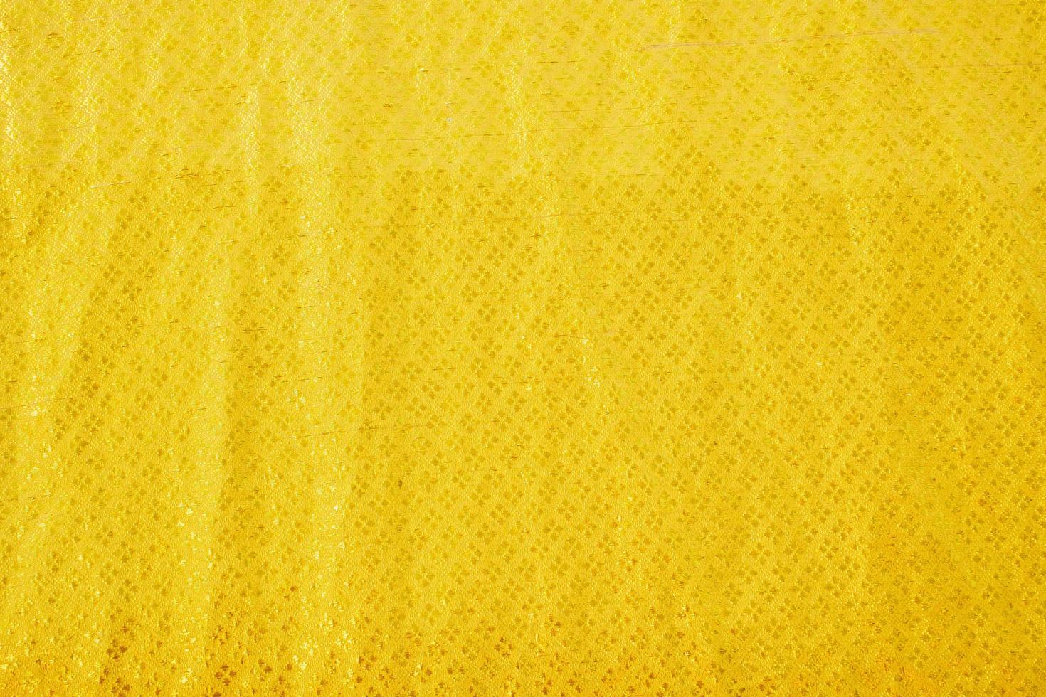 geel bed linnen helling structuur wazig kromme stijl van abstract luxe stof, gerimpeld bed linnen en goud schaduwen, achtergrond foto