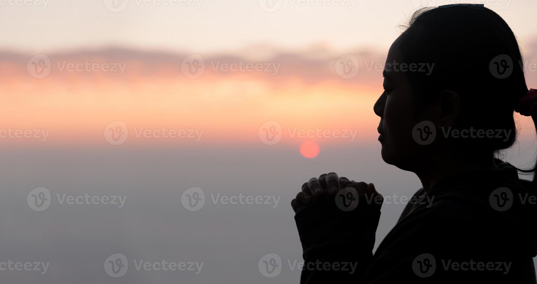 silhouet van vrouw hand- bidden geestelijkheid en geloof, vrouw aanbidden naar god. Christendom religie concept. religieus mensen zijn vernederen naar god. christenen hebben hoop geloof en geloof in god. foto