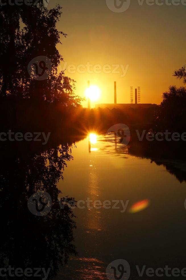 de zonsondergang visie Aan een rivier, een Woud en kleurrijk lucht. foto