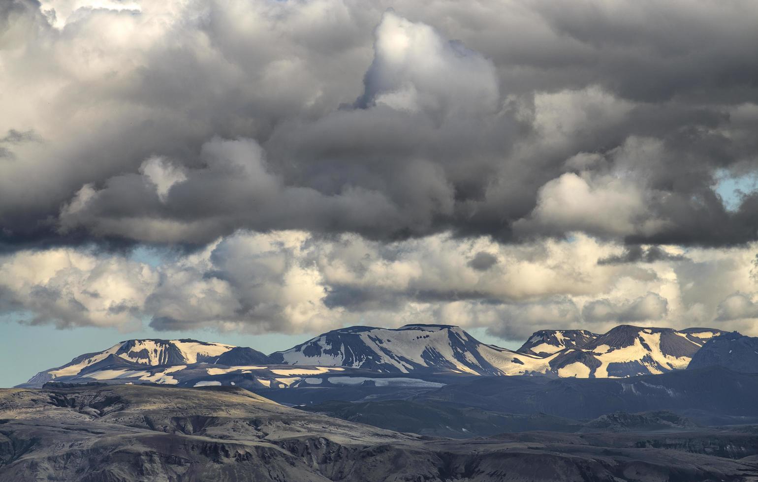 berg bedekt met sneeuw onder witte en grijze luchten foto