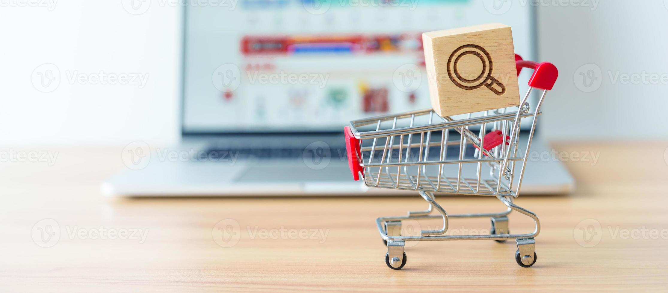 boodschappen doen kar met vergroten icoon blok en laptop computer met marktplaats website, technologie, e-commerce, seo, zoeken motor optimalisatie, reclame, trefwoord en online betaling concept foto