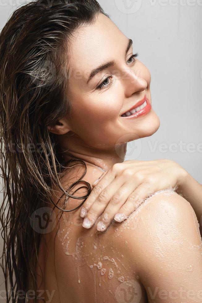 sensueel vrouw het wassen haar lichaam met douche gel foto