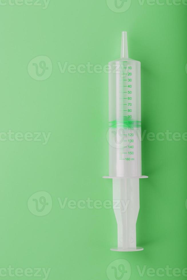 medisch injectiespuit Aan een groen achtergrond detailopname, kopiëren ruimte. de concept van minimalisme. foto