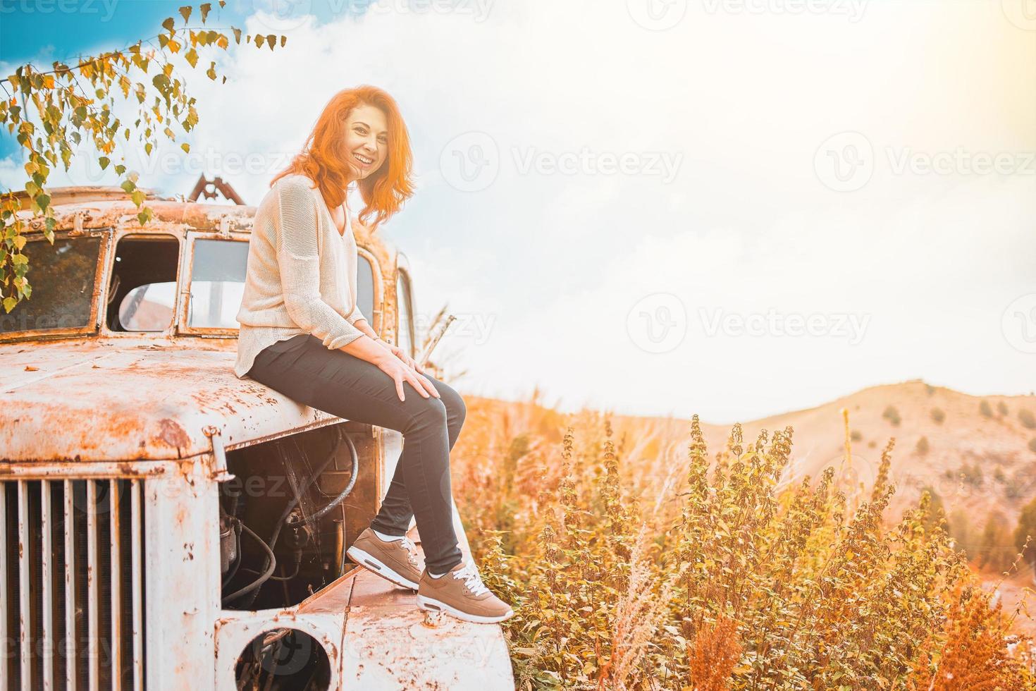 vrouw zittend Aan roestig oud klassiek vrachtwagen. foto