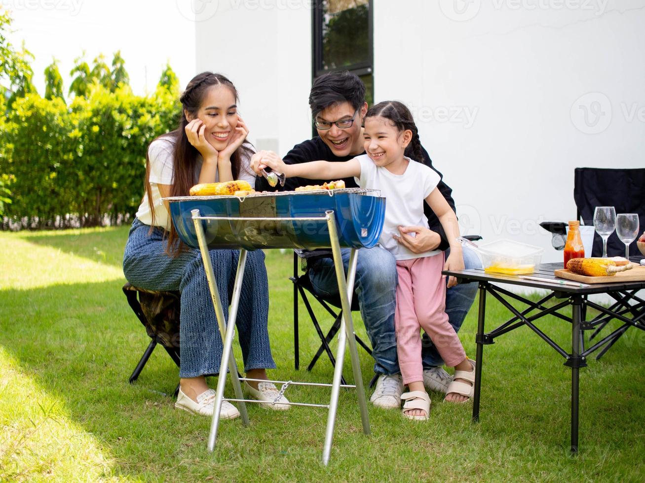 familie vader moeder zoon meisje vrouw mannetje vrouw Mens groep gelukkig buitenshuis barbeque barbecue aan het eten picknick vakantie voedsel maaltijd varkensvlees heerlijk samen vakantie tuin groen natuurlijk glimlach grappig partij foto