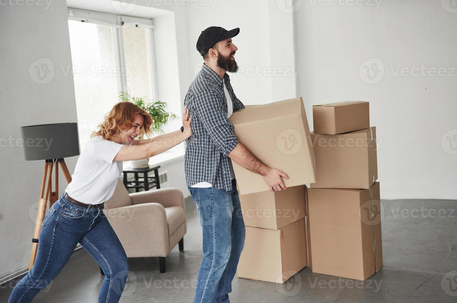 gewoon lol hebben. gelukkig paar samen in hun nieuwe huis. conceptie van bewegen foto