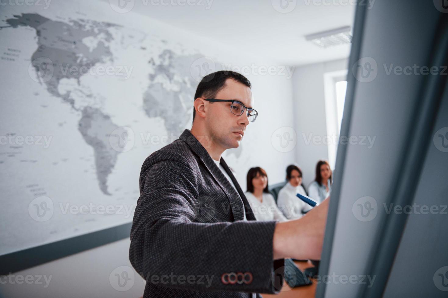 serieuze man. groep mensen op zakelijke conferentie in moderne klas overdag foto