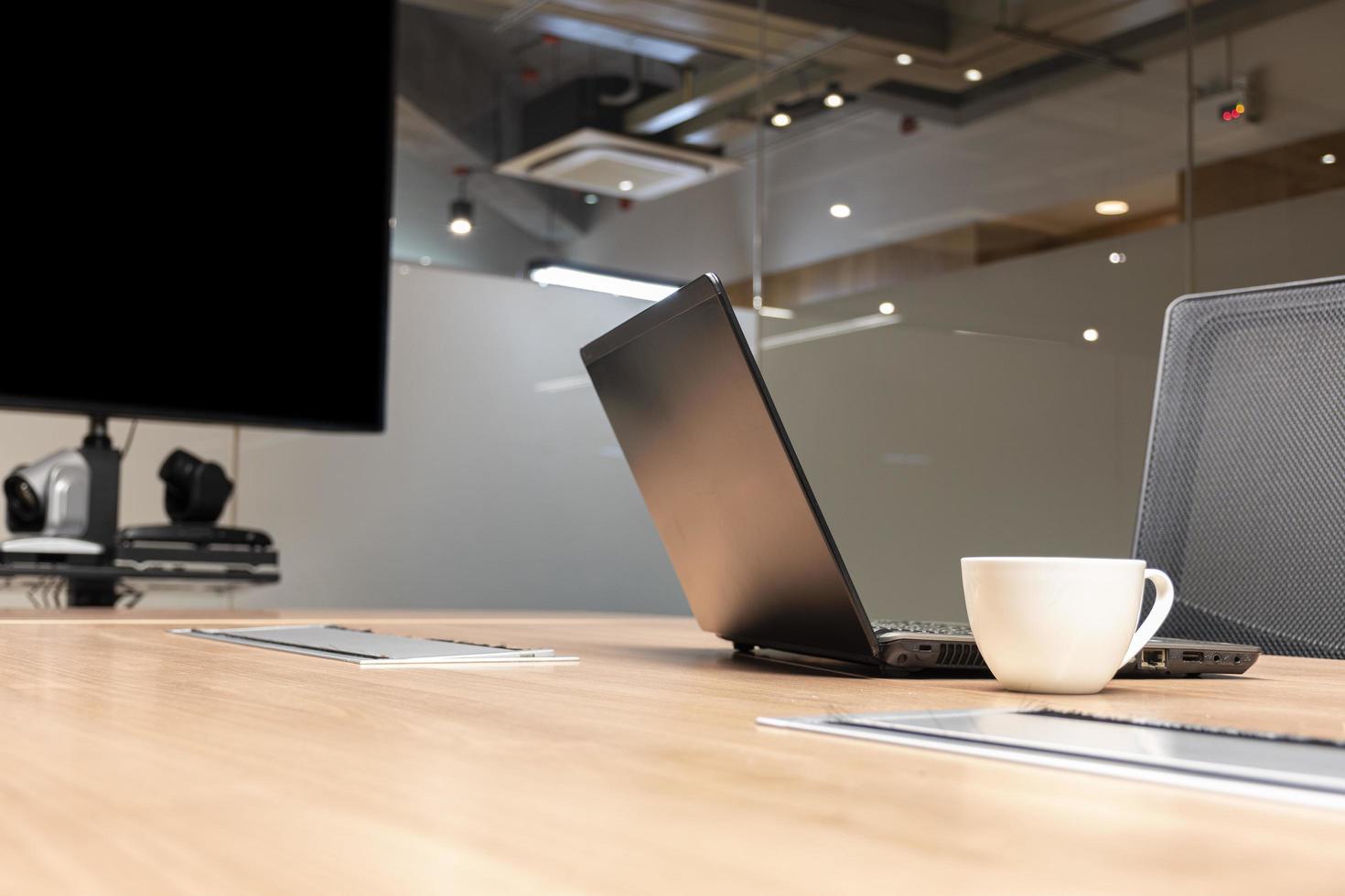 laptop en koffie kop Aan tafel in vergadering kamer foto