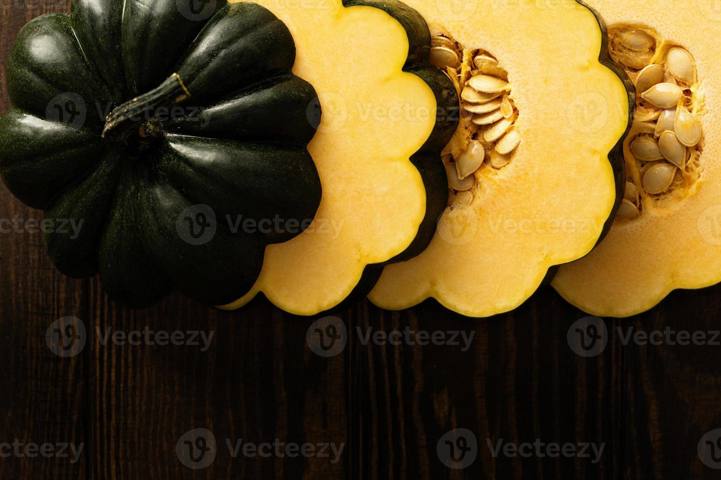 gesneden rauw eikel- squash Aan donker achtergrond foto