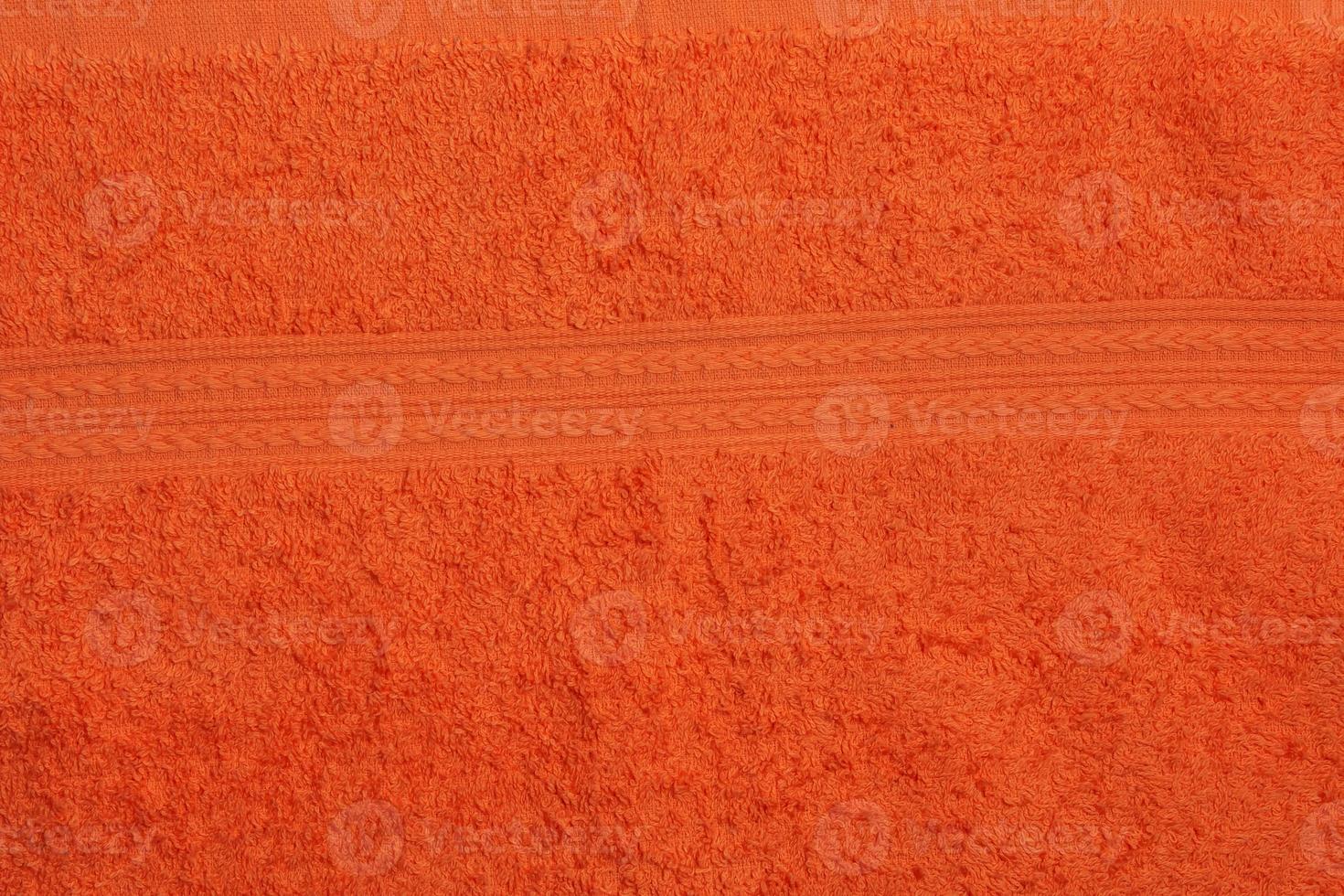 oranje badstof handdoek achtergrond. badstof kleding structuur foto