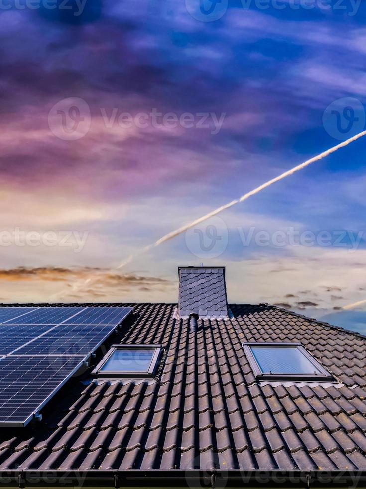 zonnepanelen die schone energie produceren op een dak van een woonhuis foto