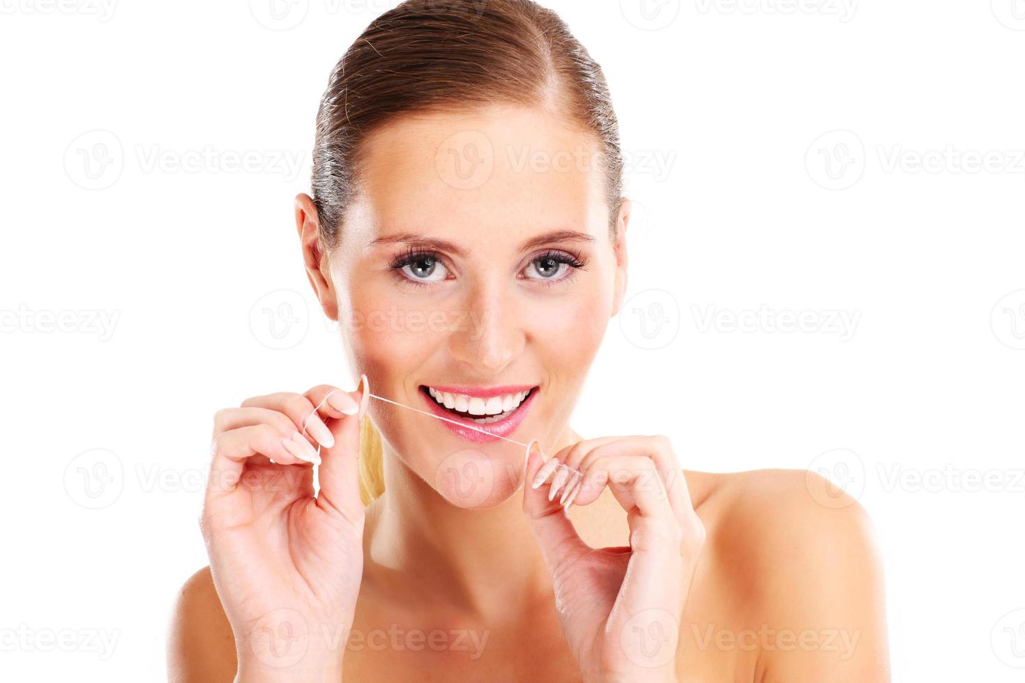 vrouw gebruik makend van tandheelkundig floss foto