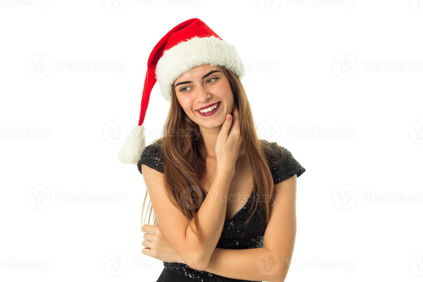 gelukkig jong meisje in de kerstman hoed foto