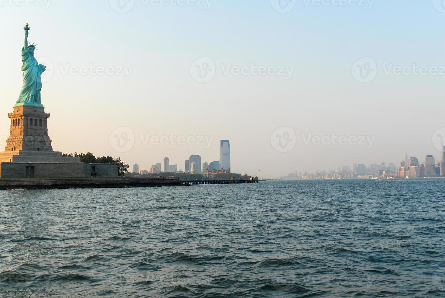 standbeeld van vrijheid Bij zonsondergang van nieuw york stad foto