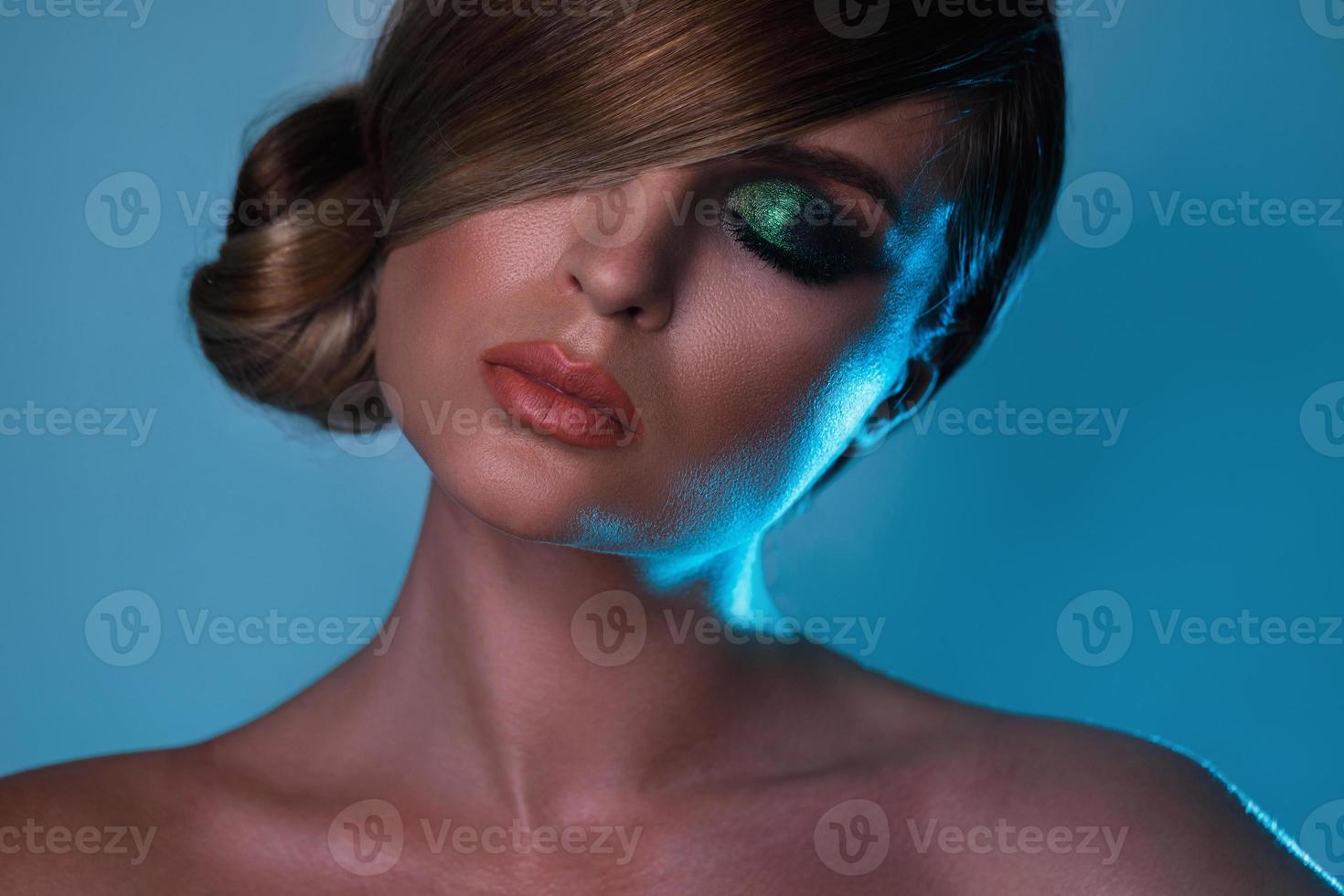 model- in elegant beeld met strak haar- aan het bedekken een oog foto