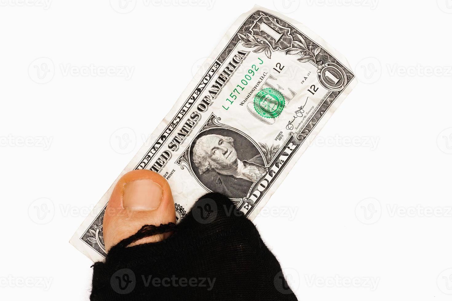 een dollar bankbiljet en heilig sok met plakken uit teen. foto