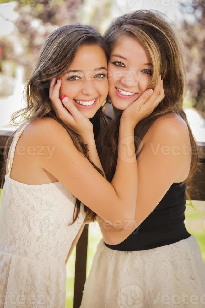 aantrekkelijk gemengd ras vriendinnetjes glimlach buitenshuis foto