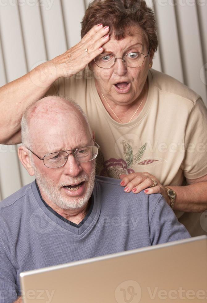 glimlachen senior volwassen paar hebben pret Aan de computer foto