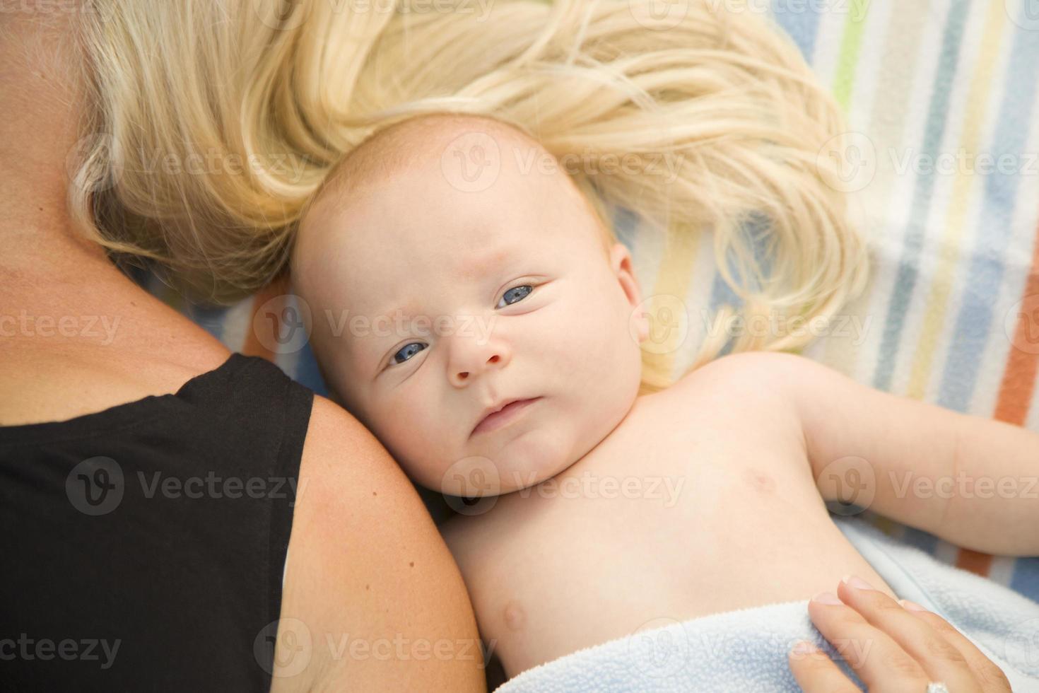 schattig baby jongen houdende De volgende naar zijn mama Aan deken foto