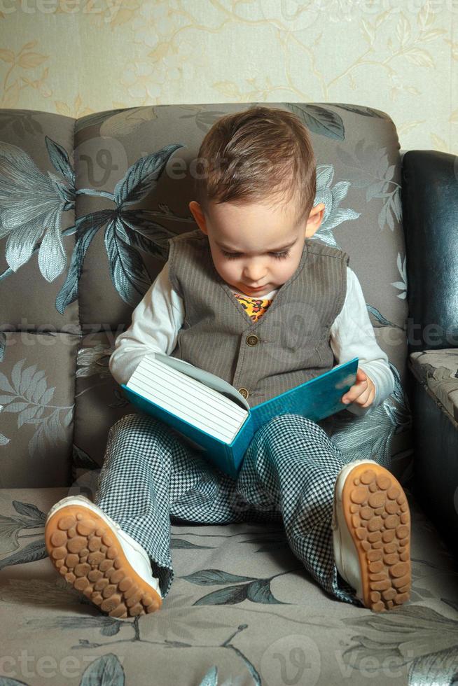 jong jongen lezen een boek foto