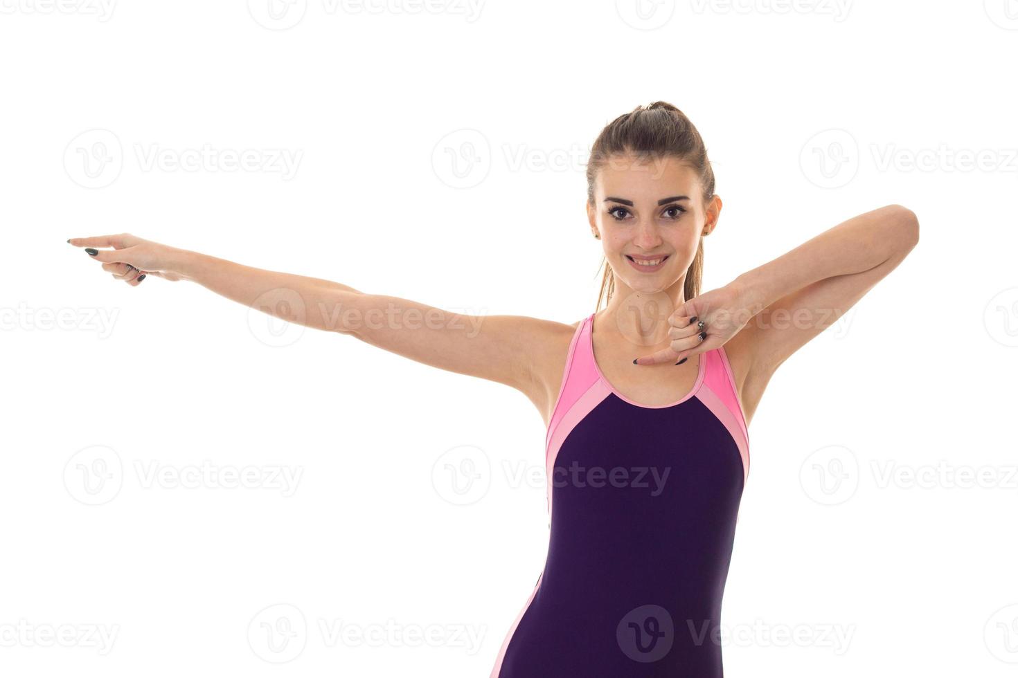 mooi jong brunette vrouw in lichaam zwempak poseren en glimlachen Aan camera geïsoleerd Aan wit achtergrond foto