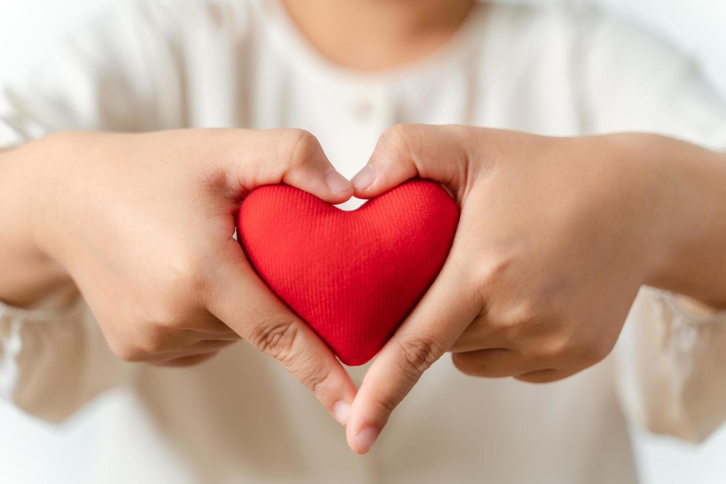 vrouw met rood hart, liefde, ziektekostenverzekering, schenking, gelukkige liefdadigheidsvrijwilliger, werelddag voor geestelijke gezondheid, wereldhartdag, Valentijnsdag foto