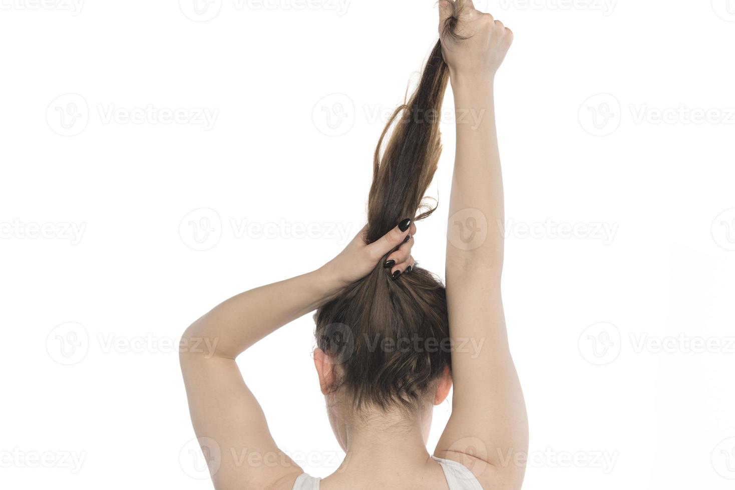 vrouw model- regelen van haar haar. vrouw koppelverkoop haar- in een broodje. foto