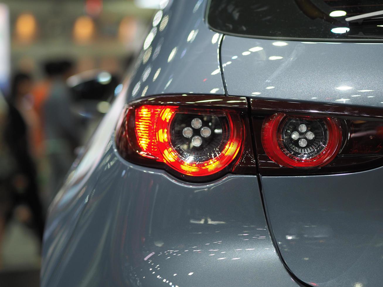 detailopname rood licht terug kant van nieuw auto glimmend grijs kleur in motor tonen evenement vervoer concept foto