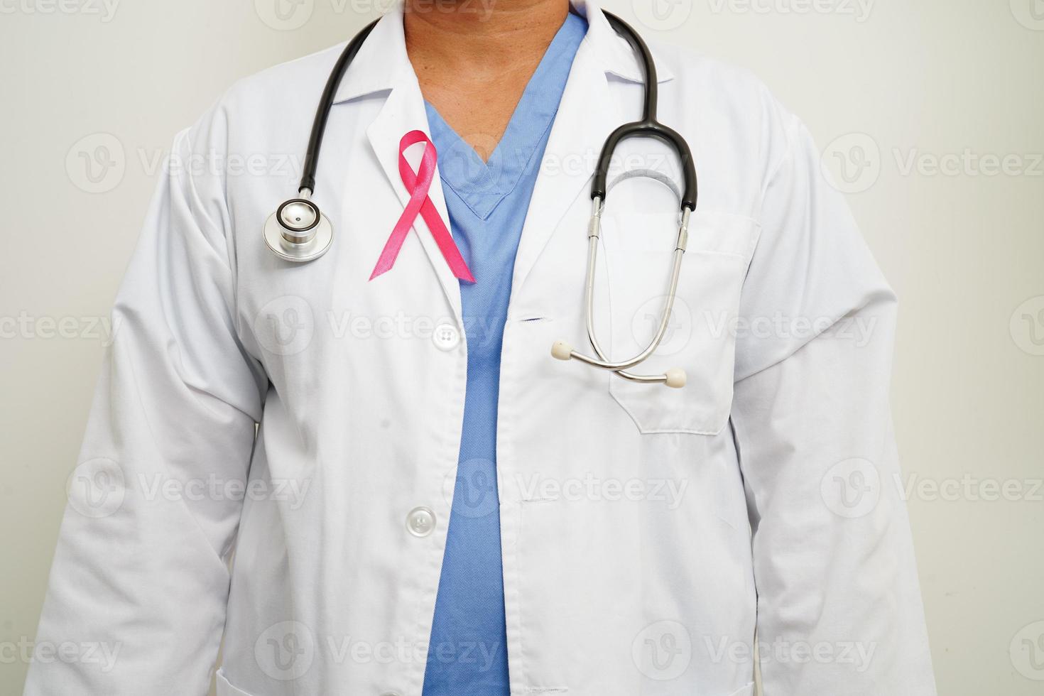 Aziatisch vrouw dokter met roze lint, wereld borst kanker dag Bij oktober. foto