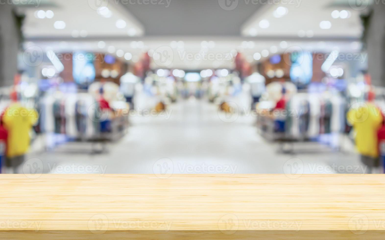 leeg hout tafel top met vervagen kleding winkel Scherm interieur boodschappen doen winkelcentrum achtergrond foto