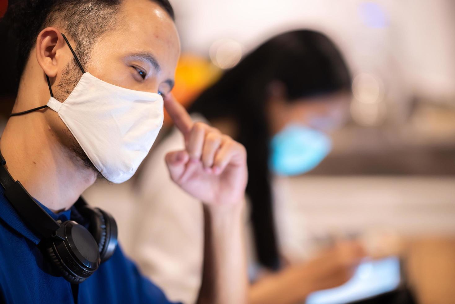 creatief team dat gezichtsmaskers draagt op zakelijke co-working-ruimte foto