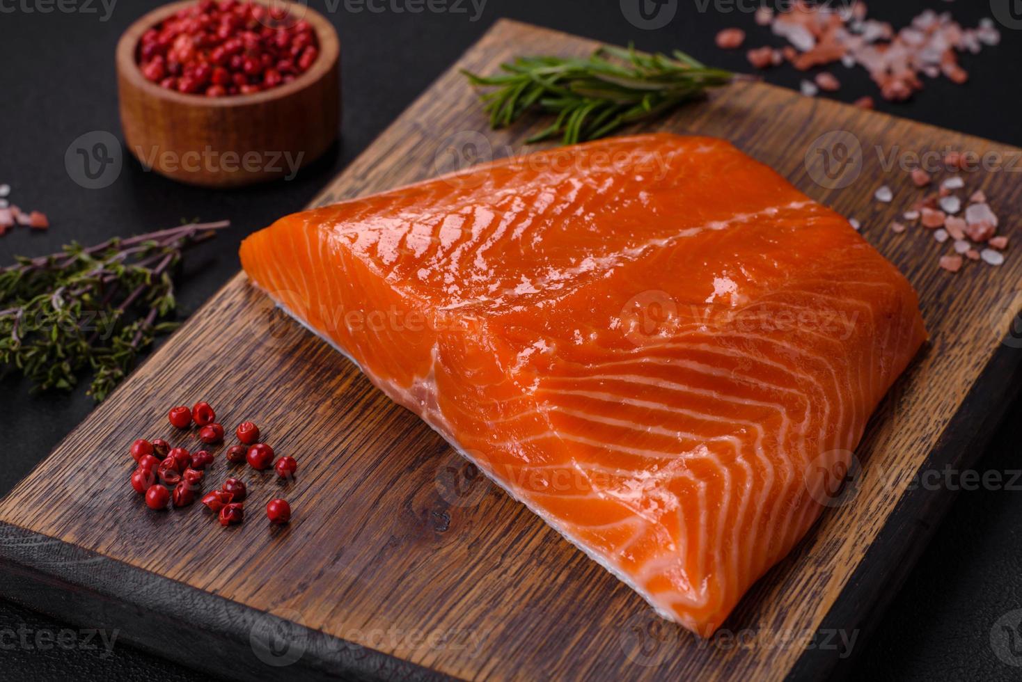 filet van rauw rood Zalm vis met zout, specerijen en kruiden foto